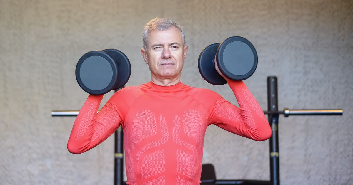 Older man lifting dumbbells in a gym, the kind of long-term resistance training the diabetes study measured