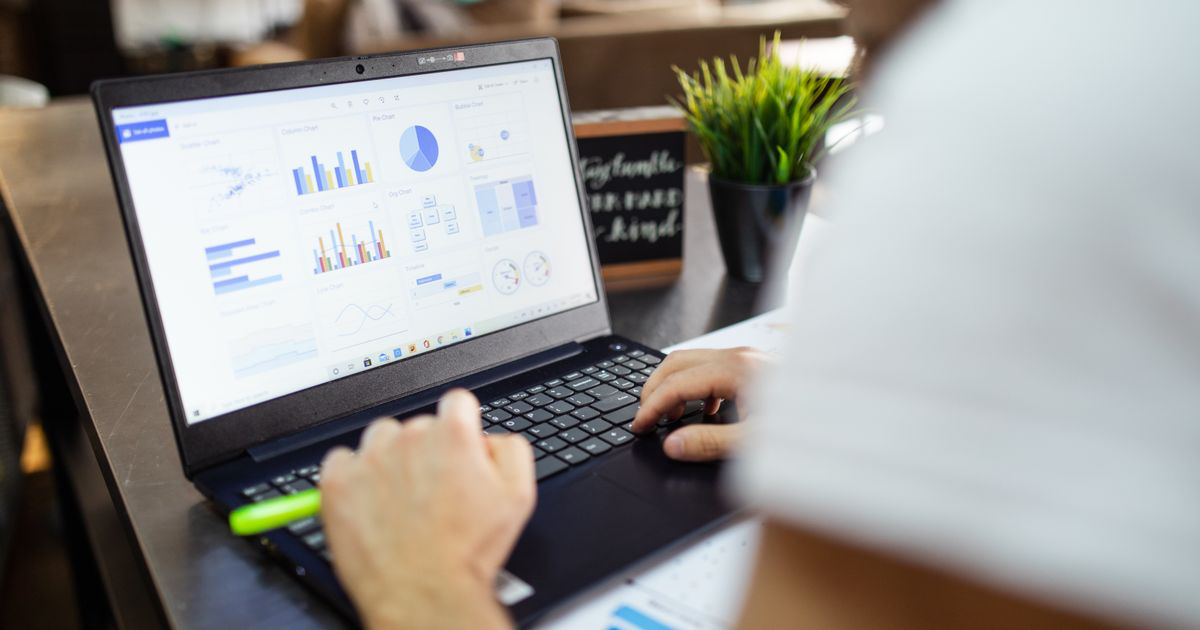 Laptop showing a spreadsheet with charts, used as a Google Sheets workout tracker template